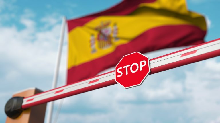 Barrier,Gate,Being,Closed,With,Flag,Of,Spain,As,A