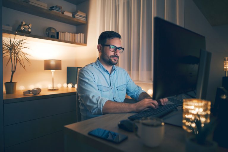 Modern,Young,Man,Working,Remotely,From,Home,At,Night.