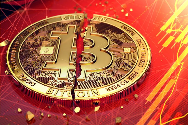 Broken,Bitcoin,Split,In,Two,Pieces,Laying,On,A,Screen.