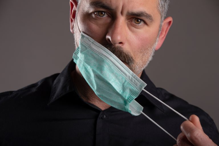 Portrait,Of,Serious,Attitude,Man,Taking,Off,Medical,Protection,Mask