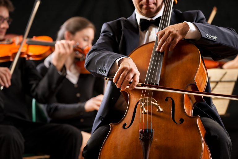Cello,Professional,Player,With,Symphony,Orchestra,Performing,In,Concert,On
