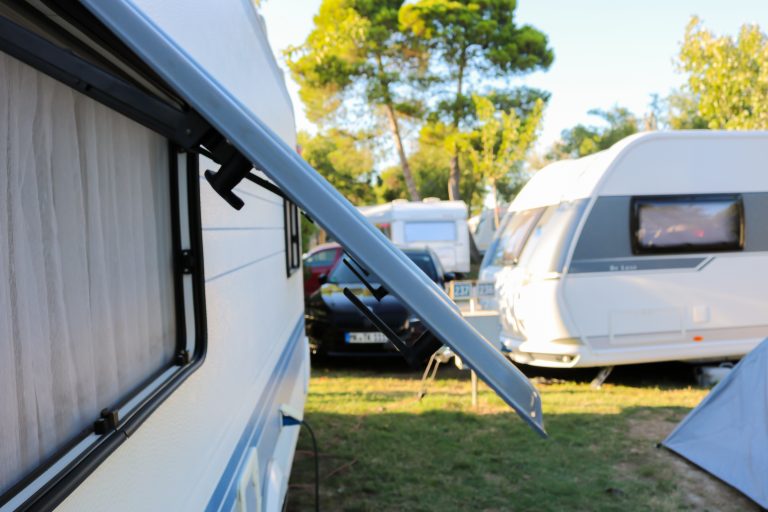 Open,Window,Of,A,Camping,Trailer,Standing,On,A,Campsite