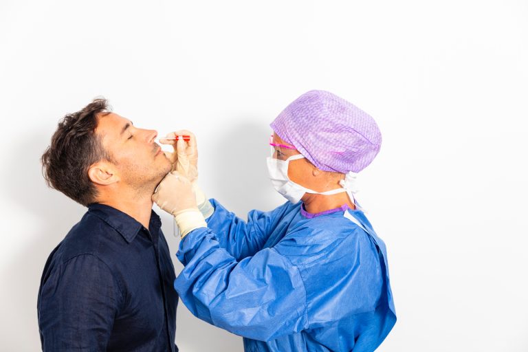 A,Doctor,In,A,Protective,Suit,Taking,A,Nasal,Swab