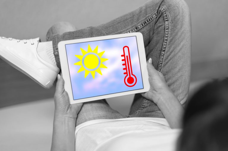 Woman,Looking,At,Heat,Wave,Concept,On,A,Tablet