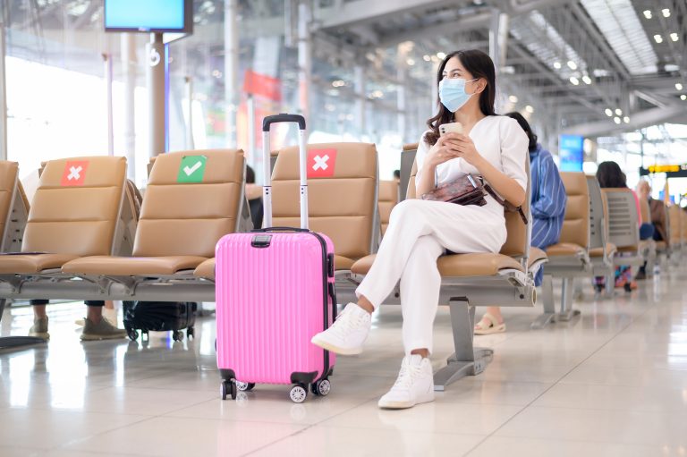 A,Traveller,Woman,Is,Wearing,Protective,Mask,In,International,Airport,