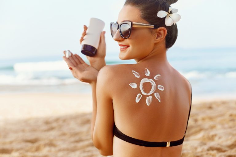 Woman,Applying,Sun,Cream,On,Tanned,Shoulder,In,Form,Of