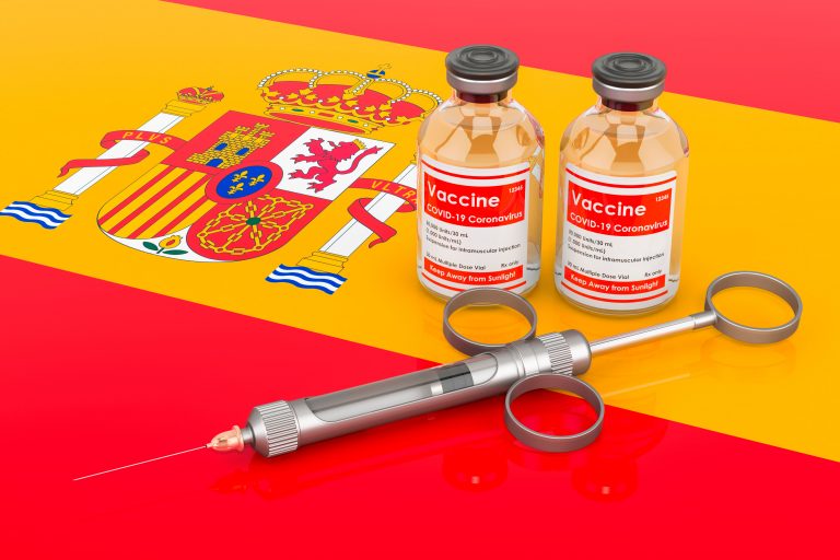 Vaccination,In,Spain,Concept.,Vaccine,Bottles,With,Syringe,On,The