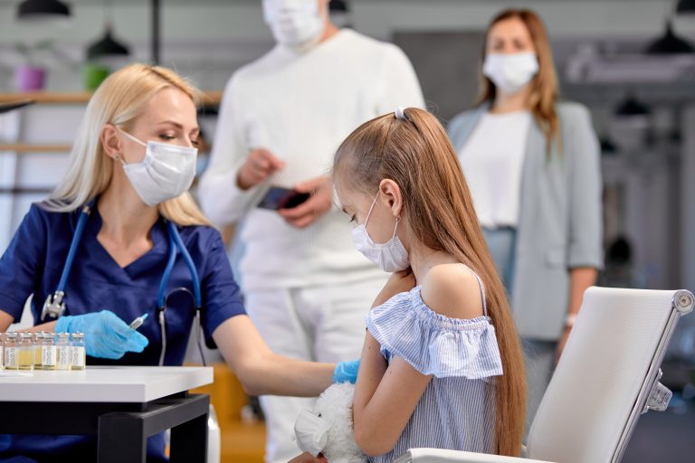 Blonde,Nurse,Give,An,Injection,Vaccine,Against,Covid-19,To,Child