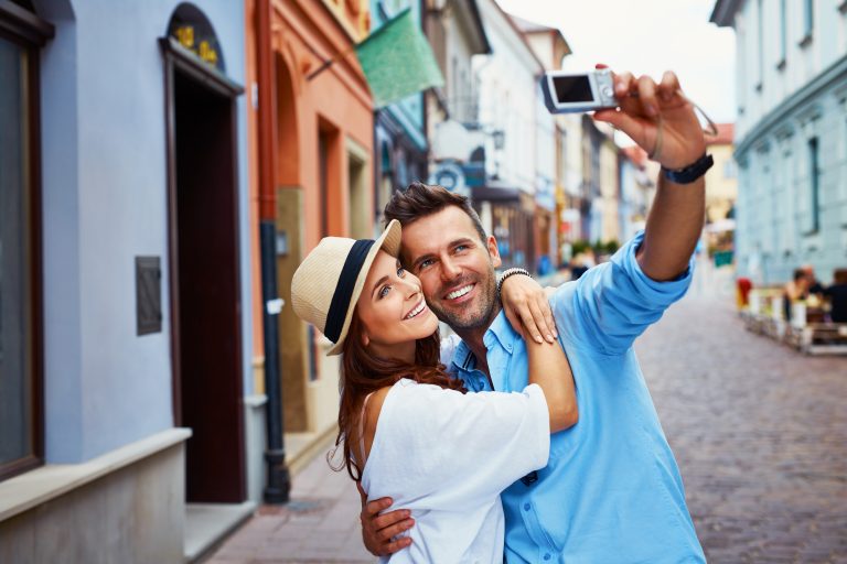 Happy,Couple,Of,Tourists,Taking,Selfie,In,Old,City