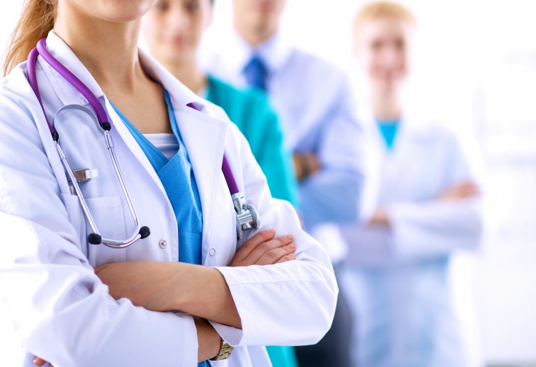 Attractive,Female,Doctor,In,Front,Of,Medical,Group