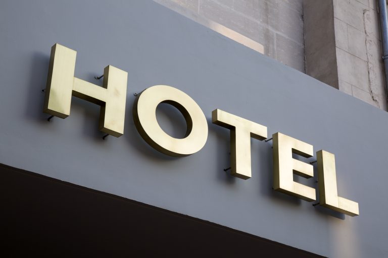Gold,Hotel,Sign,On,Grey,Background