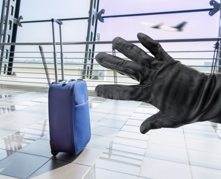 Closeup,Of,A,Hand,Of,A,Thief,Stealing,A,Suitcase