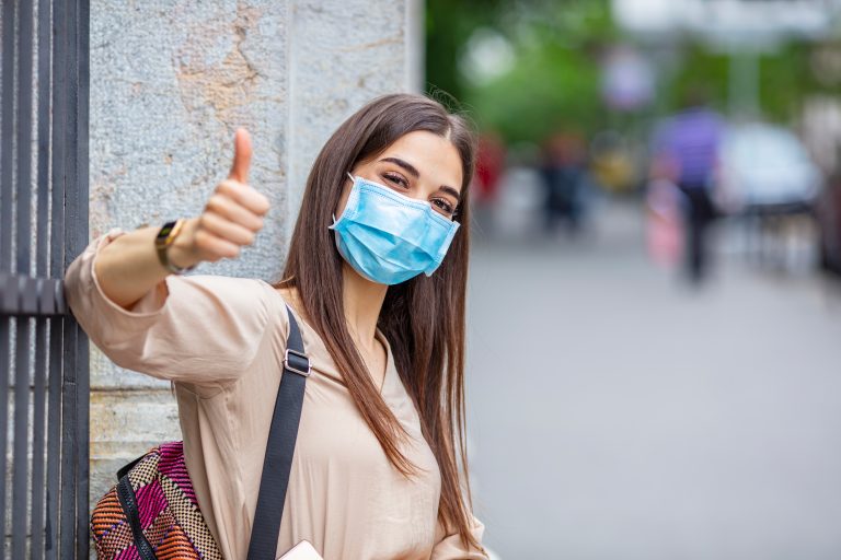 Young,Attractive,Woman,With,Mask,And,Gloves,Showing,Thumbs,Up.