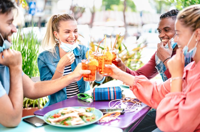 Friends,Drinking,Spritz,At,Cocktail,Bar,With,Face,Masks,-