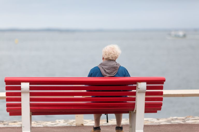 Senior,Man,Sitting,On,A,Bench,And,Looking,At,The