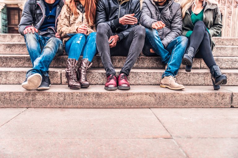 Group,Of,People,Sitting,On,A,Staircase,Outdoors,,Close,Up
