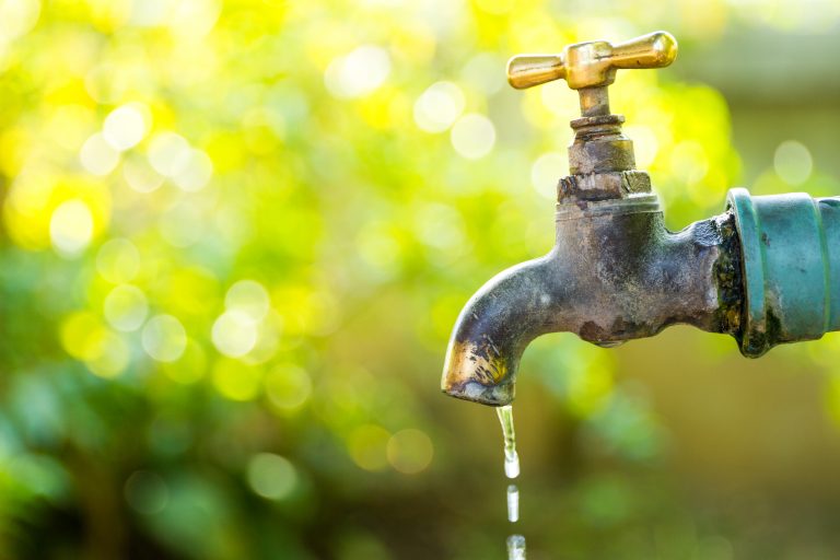 Brass,Water,Tap,In,Nature,Background.