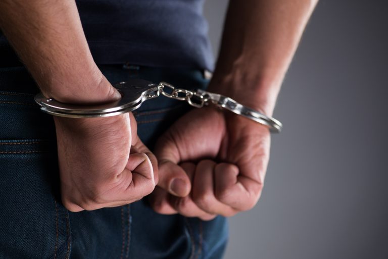 Man,With,His,Hands,Handcuffed,In,Criminal,Concept
