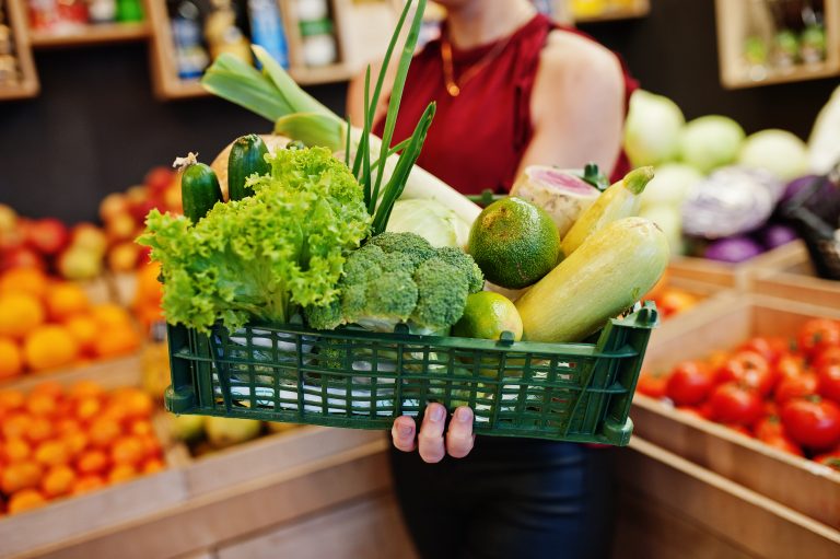 Girl,In,Red,Holding,Different,Vegetables,On,Fruits,Store.