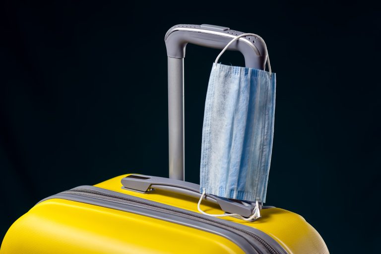 Medical,Mask,On,Luggage.,Travel,During,Coronavirus,Time.,Studio,Shot