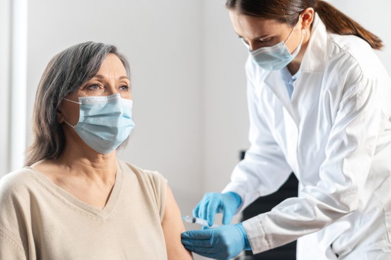 An,Elderly,Woman,Getting,A,Vaccine,For,Coronavirus,,A,Doctor