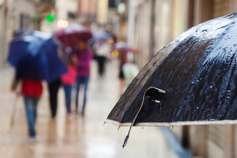 Rain,Umbrella,And,Walking,People,In,The,Rainy,City,In