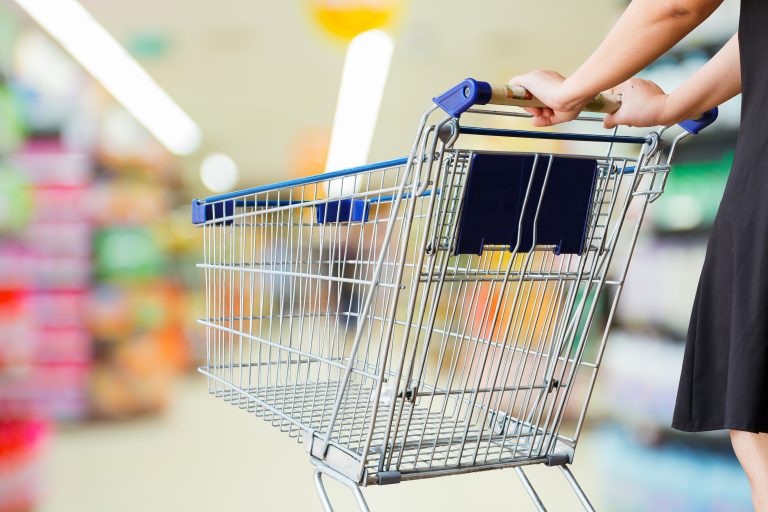 Woman,Pushing,Shopping,Cart,In,Supermarket