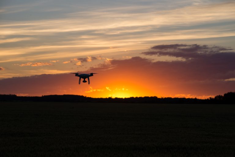 Drone,Silhouetted,Against,Orange,Sunset