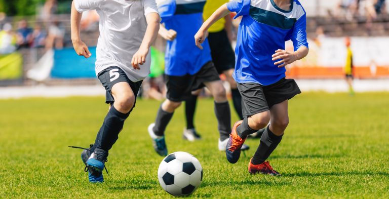 Boys,Running,And,Kicking,Soccer,Ball.,Close,Up,Action,Of