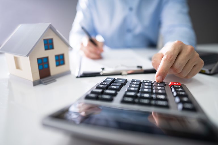 Close-up,Of,A,Person,Hand,Calculating,A,Real,Estate,Property