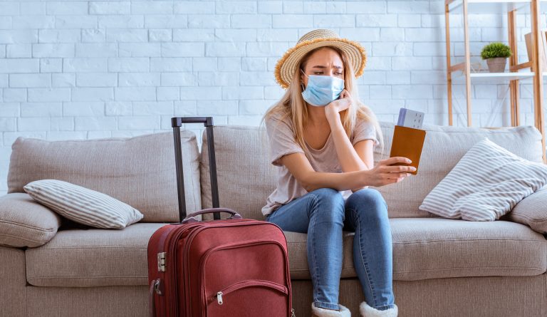 Cancellation,Of,Flights.,Sad,Girl,In,Mask,With,Tickets,And