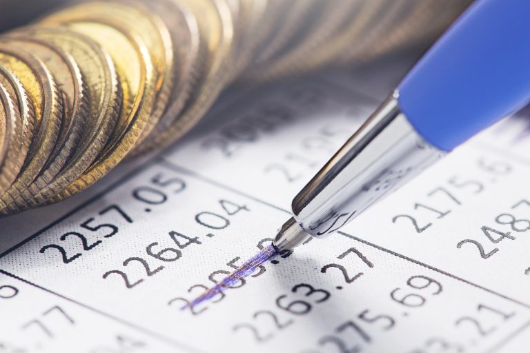 Accounting,Document,With,Pen,,Money,,Coins,And,Checking,Financial,Chart.