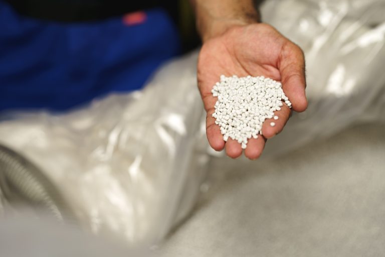 Close,Up,Of,Male,Hand,Holding,Plastic,Polymer,Granules
