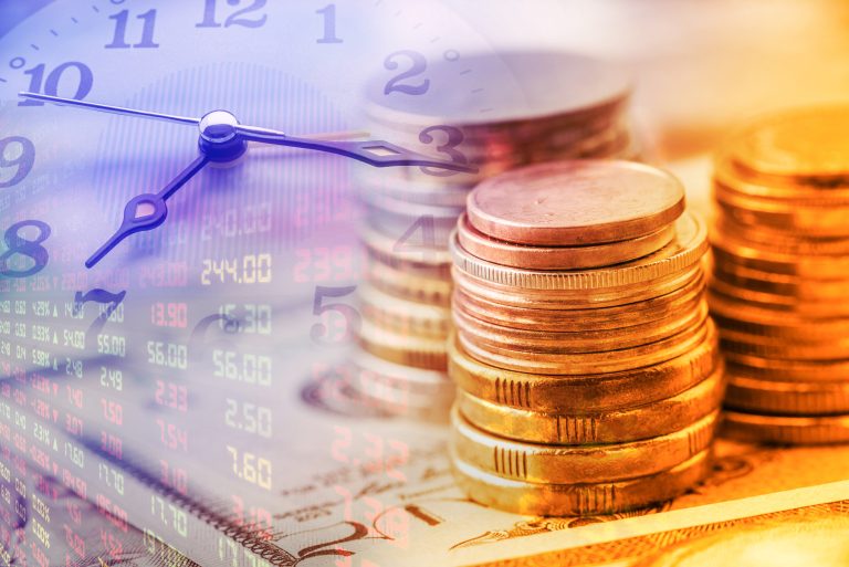 Closeup,View,:,Stack,Of,Coins,And,Clock,Hands.,A