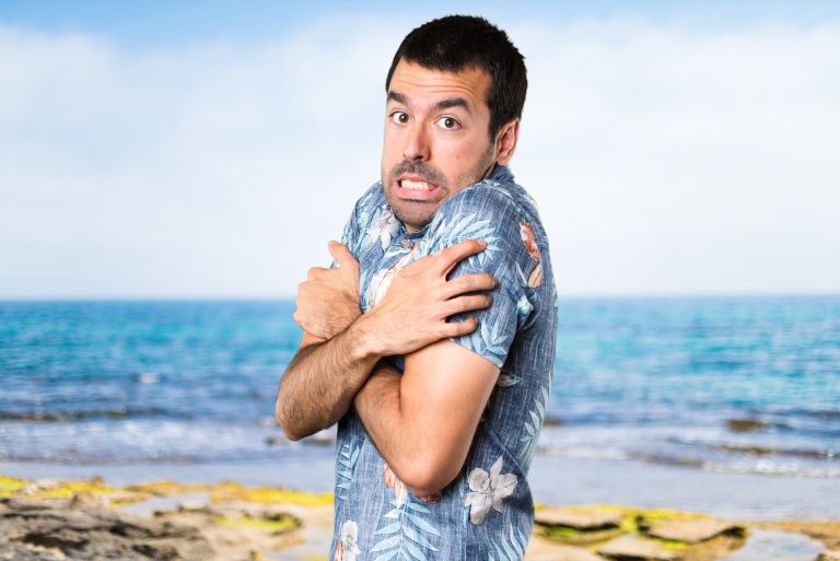 Handsome,Man,With,Flower,Shirt,Freezing,At,The,Beach