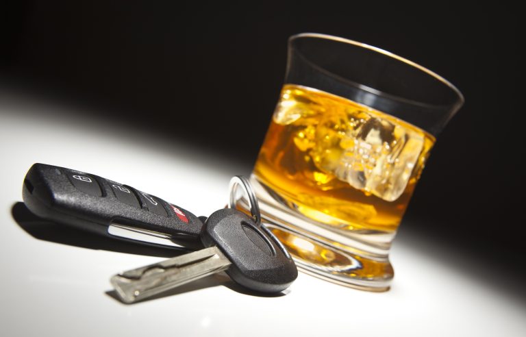 Alcoholic,Drink,And,Car,Keys,Under,Spot,Light.