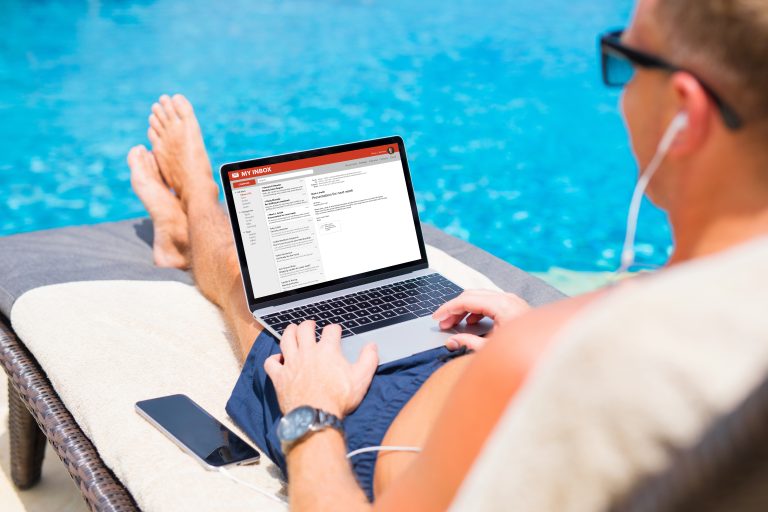 Businessman,Reading,Email,By,The,Pool
