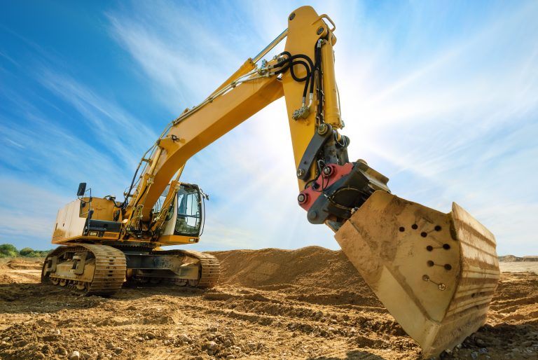 Big,Excavator,On,New,Construction,Site,,In,The,Background,The