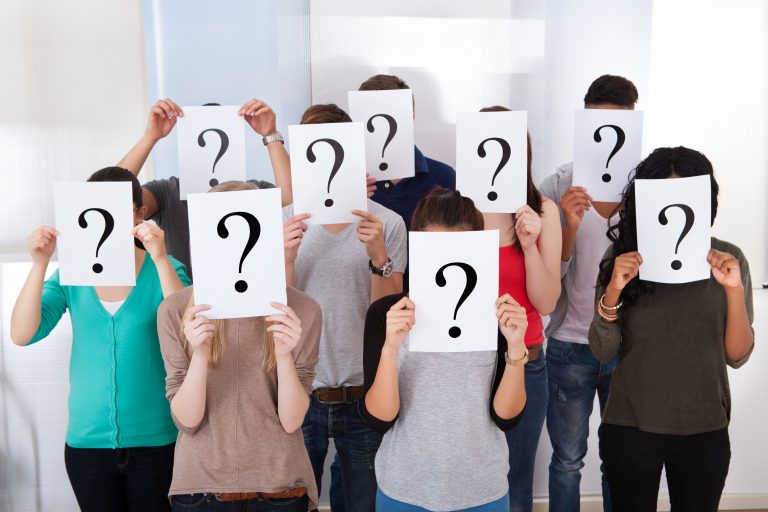 Group,Multiethnic,University,Students,Holding,Question,Mark,Signs,In,Front