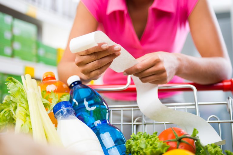 Unrecognizable,Woman,Checking,A,Long,Grocery,Receipt,Leaning,To,A