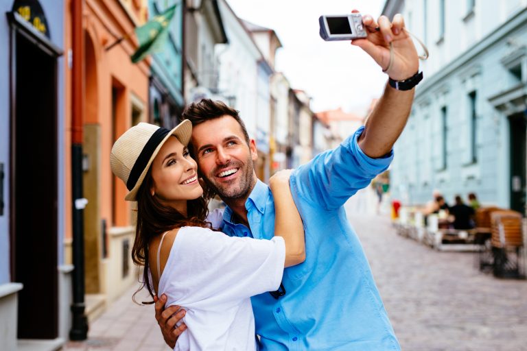 Tourists,Couple,Taking,Selfie,On,City,Street