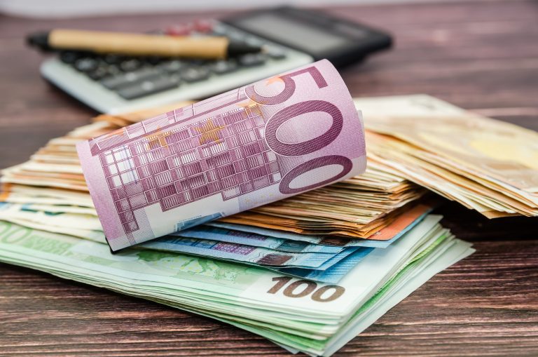 500,Euro,Banknote,Rolled,Into,A,Roll,On,The,Background