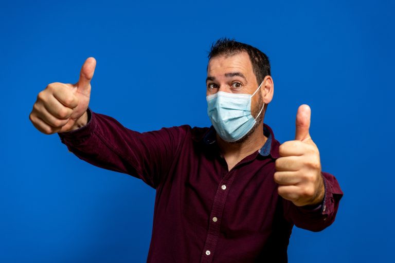 Portrait,Of,Young,Man,With,Surgical,Medical,Mask,In,Purple