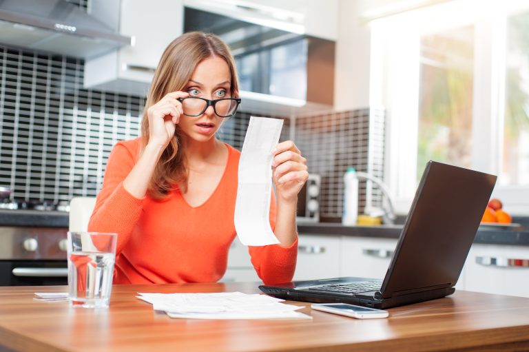Stressed,Over,Bills.,Surprised,Young,Woman,Looking,At,Her,Financial