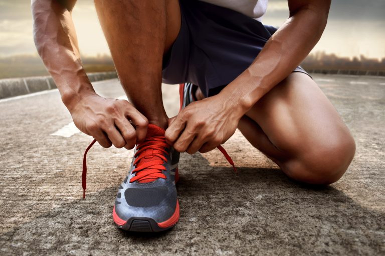 Man,Tying,Running,Shoes