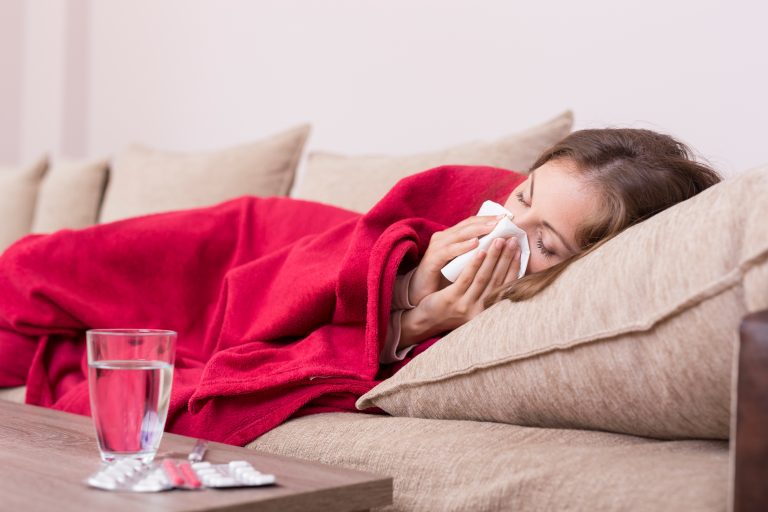 Sick,Woman,Covered,With,A,Blanket,Lying,In,Bed,With