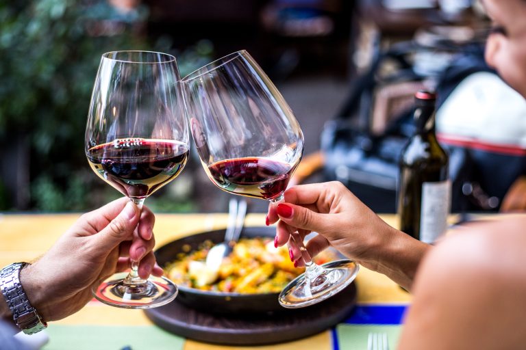 Two,Friends,/,Couple,Toasting,With,Glasses,Of,Red,Wine
