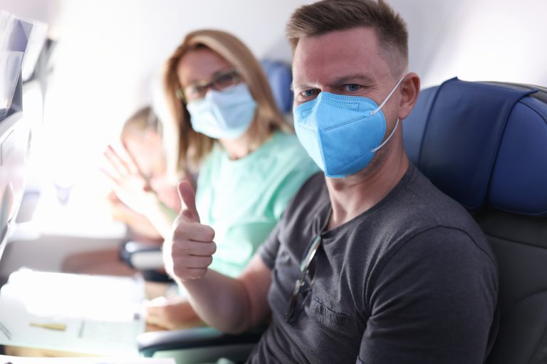 Husband,And,Wife,Are,Flying,On,Plane,Wearing,Medical,Masks.