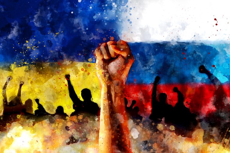 Raised,Fist,Up,Against,Background,Of,Ukrainian,And,Russian,National