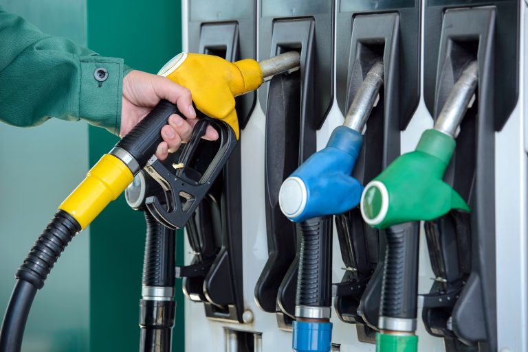 Close-up,Of,A,Men's,Hand,Using,A,Fuel,Nozzle,At